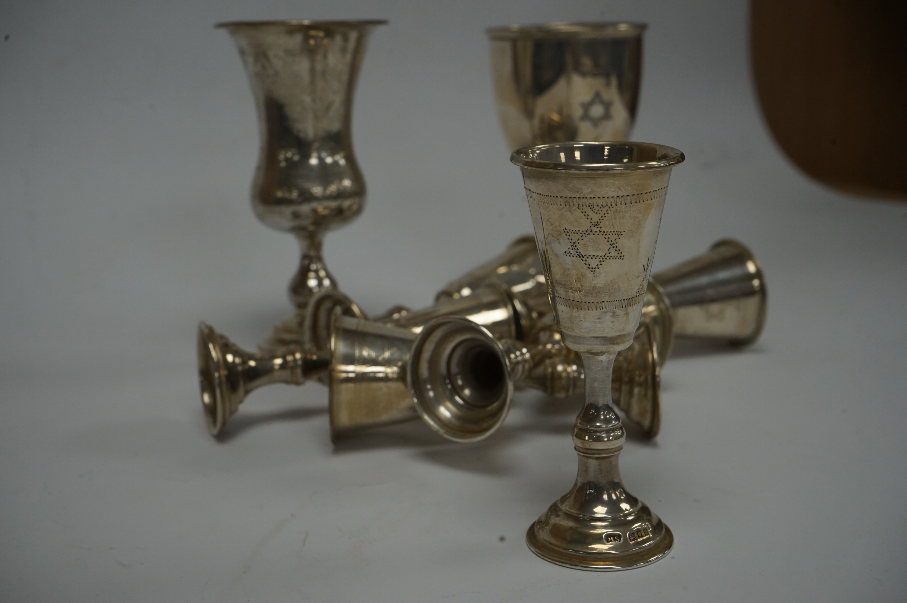 A set of six George V silver kiddush cups, maker MS?, London, 1924, 95mm, together with one other larger earlier silver kiddush cup and a 1960's silver goblet. Condition - poor to fair